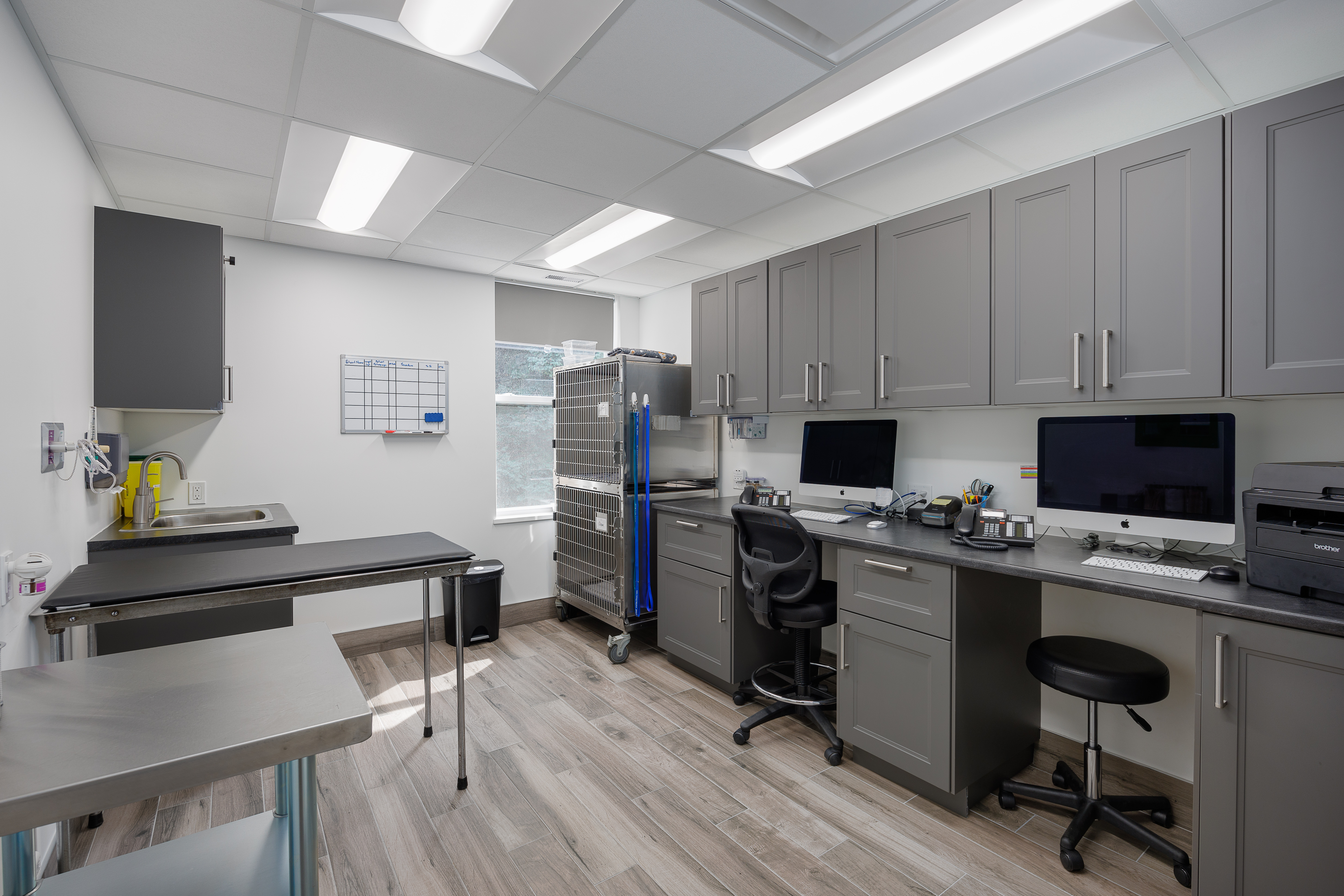 The image displays a modern kitchen with stainless steel appliances, grey cabinets, and a clean countertop.